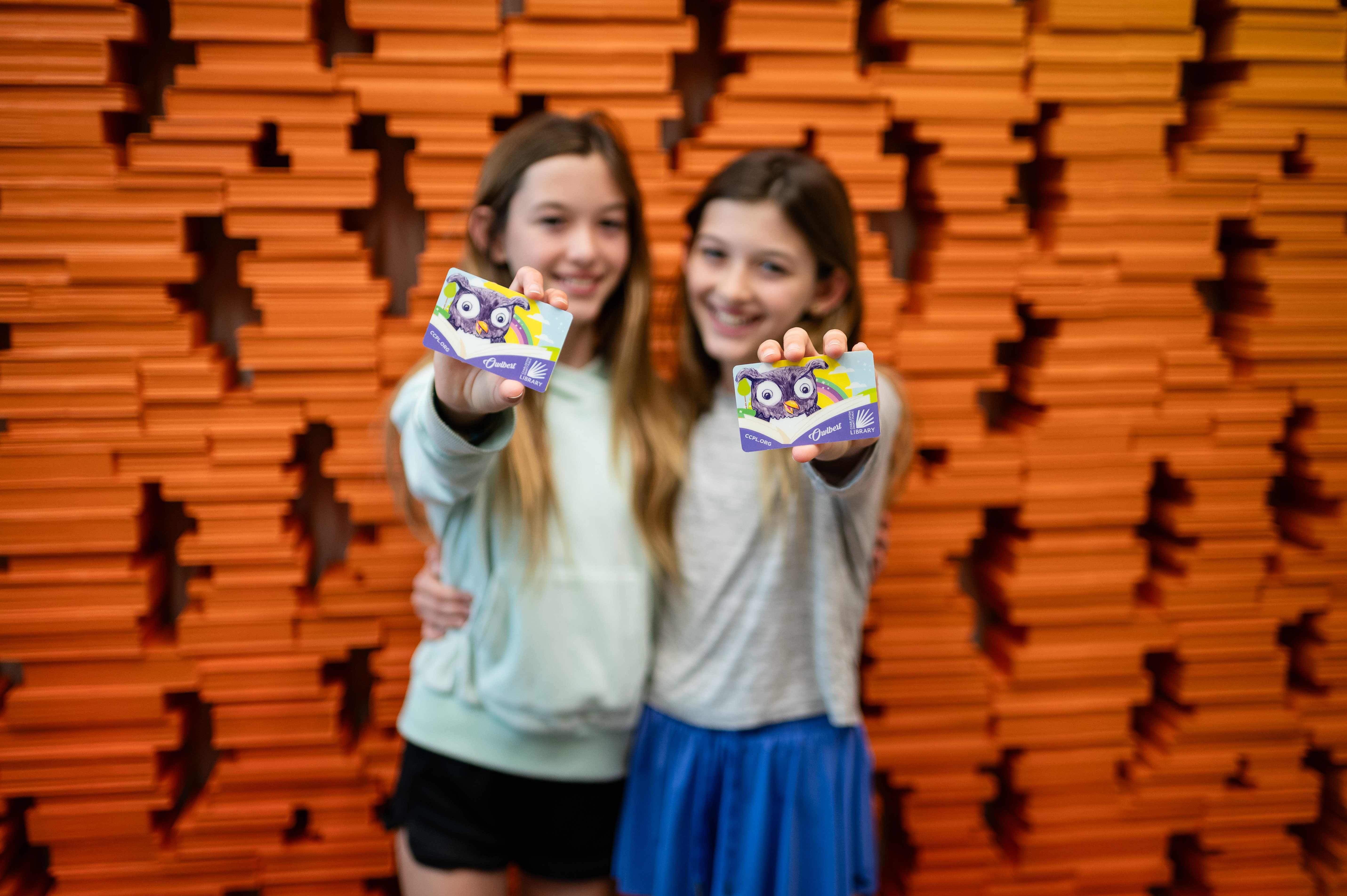 Two kids holding library cards at the Charleston County Public Library!