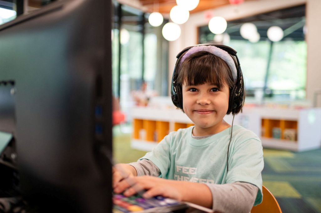 A child using a computer at a local library