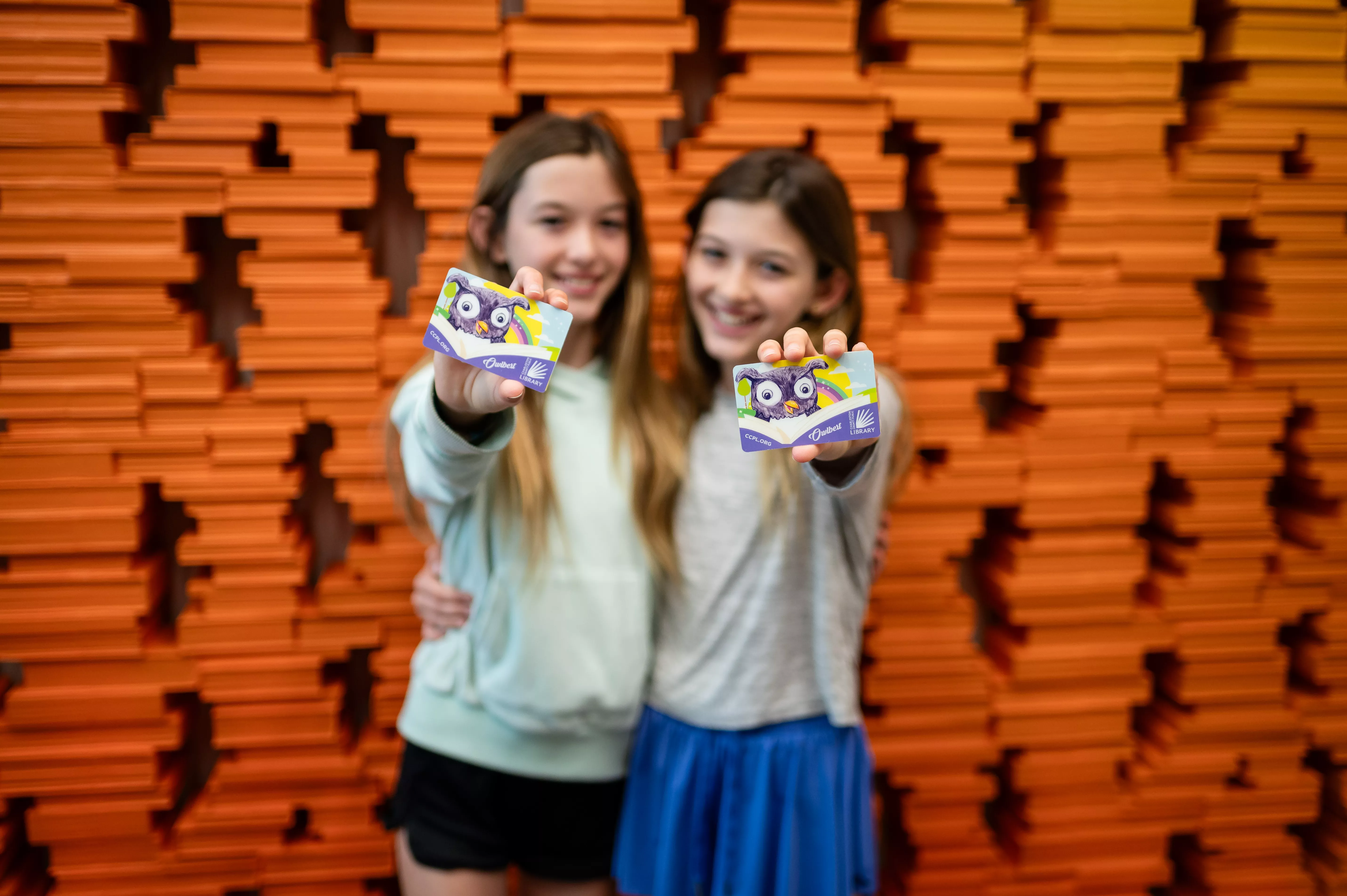 Two kids holding library cards at the Charleston County Public Library!
