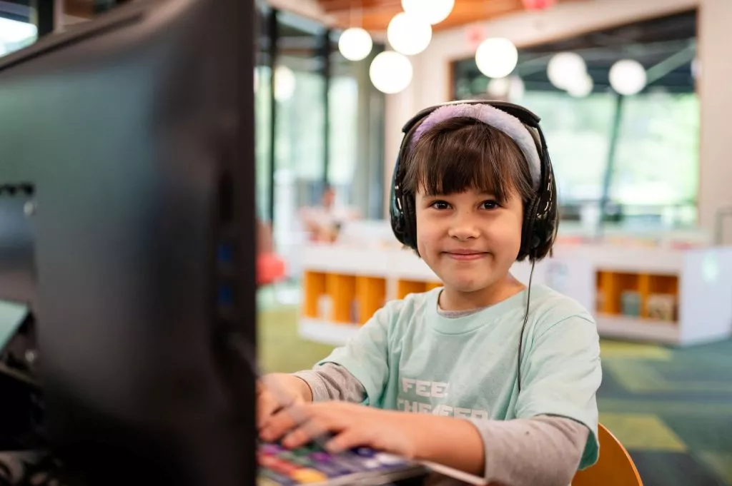 A child using a computer at a local library